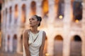 Fashion model with coloseum in the background. Rome, Italy Royalty Free Stock Photo