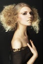 Fashion model with curly hair in black tunic Royalty Free Stock Photo