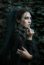 Fashion model dressed in gothic style. Vamp. Royalty Free Stock Photo