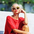 Fashion model girl. Beauty stylish blonde woman posing outdoor i
