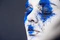 Fashion model girl portrait with colorful powder make up. woman with bright blue makeup and white skin. Abstract fantasy Royalty Free Stock Photo