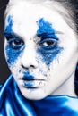 Fashion model girl portrait with colorful powder make up. woman with bright blue makeup and white skin. Abstract fantasy Royalty Free Stock Photo