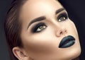 Fashion model girl portrait with trendy gothic black makeup. Young woman with black lipstick, dark smokey eyes Royalty Free Stock Photo