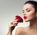 Fashion model girl with red rose in her hand Royalty Free Stock Photo