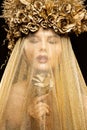 Fashion Model in Gold Flowers Hat Veil, Beautiful Woman Art Portrait with Golden Rose Flower