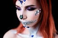 Fashion model with halloween skull makeup with glitter and rhinestones