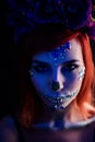 Fashion model with halloween skull makeup with glitter and rhinestones with creative color lightning Royalty Free Stock Photo