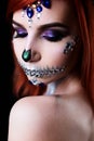 Fashion model with halloween skull makeup with glitter and rhinestones