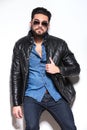 Fashion model in leather jacket and sunglasses posing Royalty Free Stock Photo