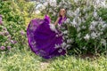 Fashion Model in Lilac Flowers, Young Woman in Beautiful Long Dress Waving on Wind, Outdoor Beauty Portrait in Blooming