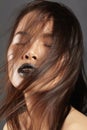 Fashion Model with Long Blowing Hair. Glamour Asian Beautiful Woman with Beautiful Brown Hair. Fashion Style, Clean Skin Royalty Free Stock Photo