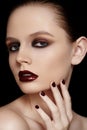 Fashion model with maroon manicure, make-up