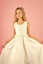 Fashion model on pink background, beauty. Child girl in stylish glamour dress, elegance. Look, hairdresser, makeup