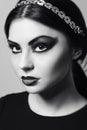 Fashion model portrait. Scarlet makeup. Black arrows. Royalty Free Stock Photo