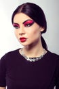 Fashion model portrait. Scarlet makeup. Black arrows. Royalty Free Stock Photo