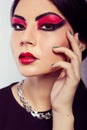 Fashion model portrait. Scarlet makeup. Black arrows. Royalty Free Stock Photo