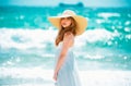 Fashion model posing on the beach. Summer dress fashionable woman clothes. Young beautiful hipster woman on tropical Royalty Free Stock Photo