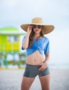 Fashion model posing on the beach. Summer dress fashionable woman clothes. Young beautiful hipster woman on tropical Royalty Free Stock Photo