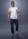 Fashion model posing in jeans and white t-shirt Royalty Free Stock Photo
