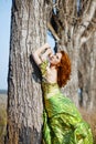 Fashion model posing in near tree Royalty Free Stock Photo