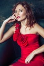 Fashion model posing in red dress. Royalty Free Stock Photo