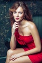 Fashion model posing in red dress. Royalty Free Stock Photo