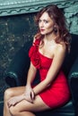 Fashion model posing in red dress. Royalty Free Stock Photo