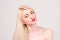 Fashion model posing at studio. Beautiful woman with long straight blond hair, red lips and make-up Royalty Free Stock Photo