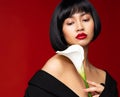 Fashion Model with Red Lipstick. Asian Woman Beauty with Black Bob Hairstyle over Red Background. Elegant Lady Face Portrait Royalty Free Stock Photo