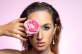 Fashion model with rose flower on bright background. Beautiful young woman portrait Royalty Free Stock Photo