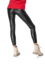 Shapely female legs in black leggings and boots isolated on white background Royalty Free Stock Photo