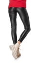 Shapely female legs in black leggings and boots isolated on white background Royalty Free Stock Photo