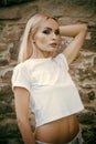 Fashion model, style, glamour. Woman with belly in tshirt, fashion. Sensual woman with long blond hair, makeup face Royalty Free Stock Photo