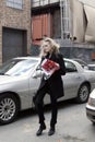 Fashion model taking on cellphone Street Style during Fashion Week
