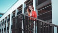 Fashion model wearing red hoodie with inscription los angeles posing at parking Royalty Free Stock Photo