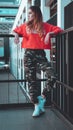 Fashion model wearing red hoodie with inscription los angeles posing at parking