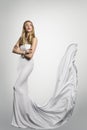 Fashion Model White Dress, Woman in Long Gown with Waving Tail, full length studio portrait Royalty Free Stock Photo