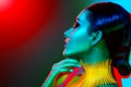 Fashion model woman in colorful bright lights