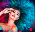 Fashion model woman in colorful bright lights posing. Beautiful girl with trendy makeup Royalty Free Stock Photo