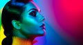 Fashion model woman in colorful bright lights posing. Portrait of girl with trendy makeup Royalty Free Stock Photo