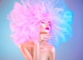 Fashion model woman in colorful bright lights posing, portrait of beautiful girl with trendy makeup and colorful pink hairdo Royalty Free Stock Photo