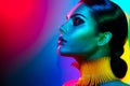 Fashion model woman in colorful bright lights posing. Portrait of girl with trendy makeup Royalty Free Stock Photo