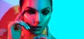 Fashion model woman in colorful bright lights with trendy makeup and manicure posing Royalty Free Stock Photo