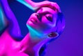 Fashion model woman in colorful bright neon lights posing in studio. Portrait of beautiful sexy dancing girl in UV Royalty Free Stock Photo