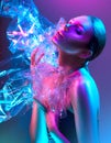 Fashion model woman in colorful bright neon lights posing in studio through transparent film. Portrait of beautiful girl in UV Royalty Free Stock Photo