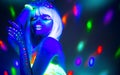 Fashion model woman dancing in neon light, disco night club. Beautiful dancer model girl colorful bright fluorescent make-up
