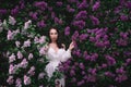 Fashion model, woman in lilac purple garden. Luxury fragrance concept Royalty Free Stock Photo