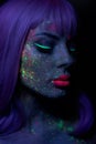 Fashion model woman in neon light bright fluorescent makeup, long hair, drop on face. Beautiful model pink hair girl colorful make Royalty Free Stock Photo