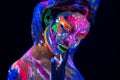 Fashion model woman in neon light, portrait of beautiful model girl with fluorescent make-up, Body Art design of female Royalty Free Stock Photo