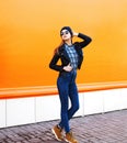 Fashion model woman wearing a rock black style posing over orange Royalty Free Stock Photo